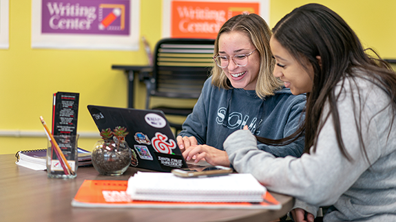 Students looking at laptop